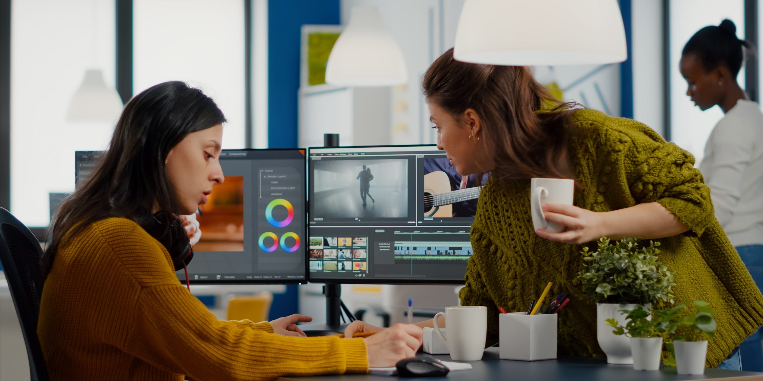 Colleagues discussing about video project adjusting film footage